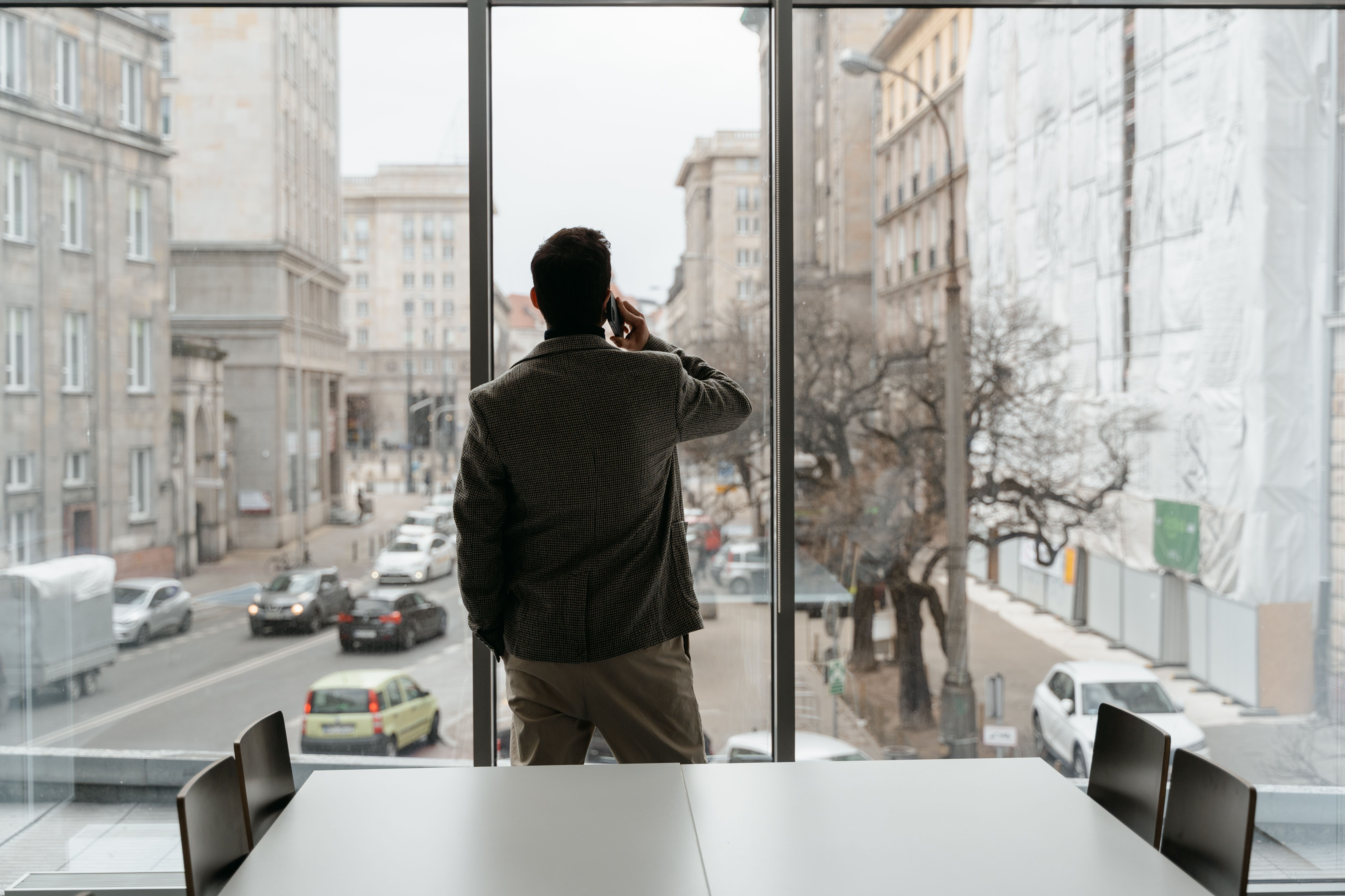 Advisor on the phone with a client, looking out over the city