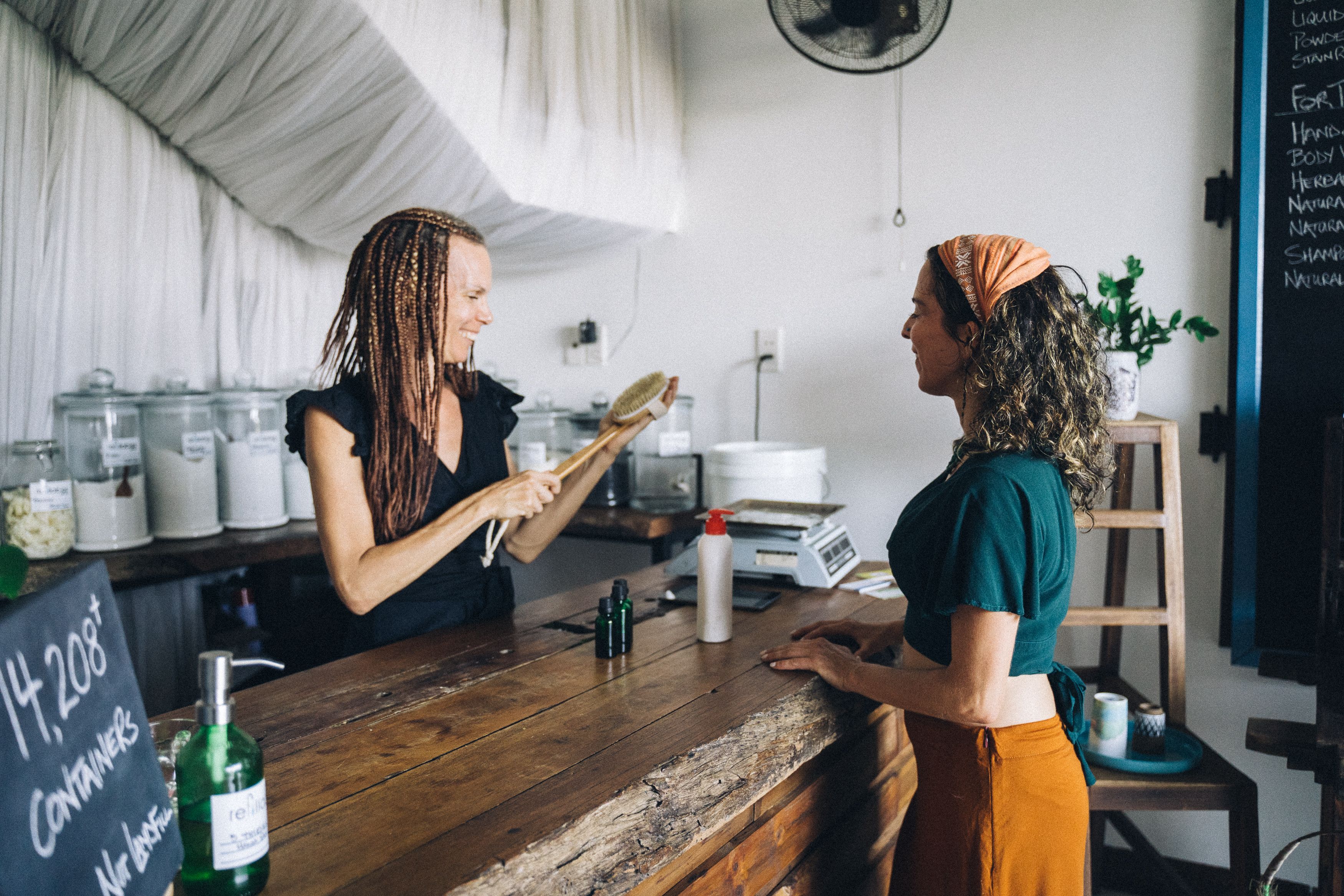 Small business owner helping a customer at the counter
