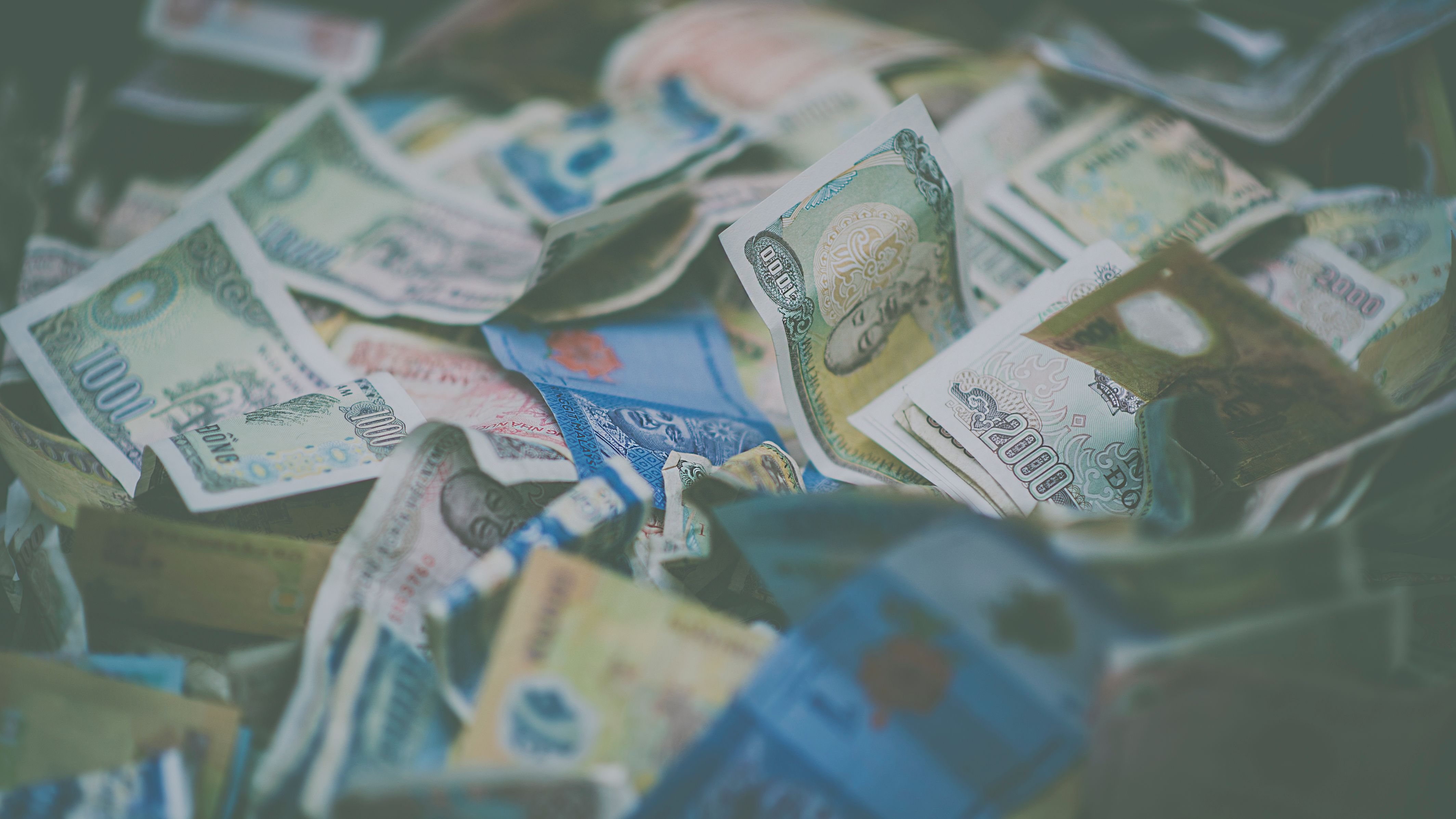 Pile of international currency, representing cross-border finances