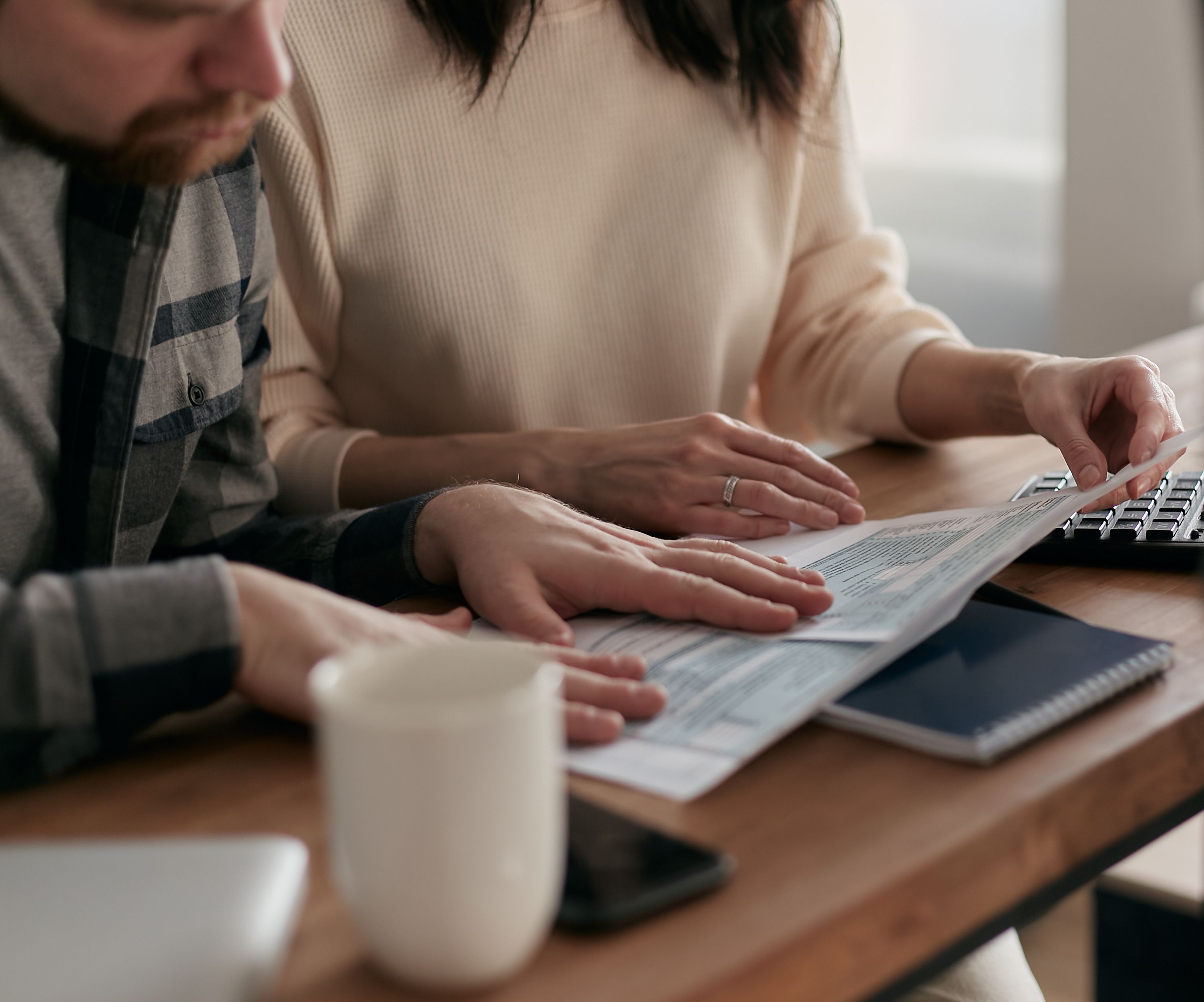Couple reviewing tax paperwork together at their kitchen table